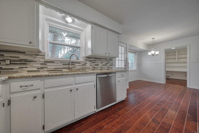 kitchen with dark wood-type flooring, white cabinetry, hanging light fixtures, and stainless steel dishwasher