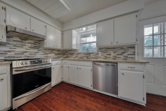 kitchen with dark wood-type flooring, sink, light stone countertops, white cabinetry, and stainless steel appliances