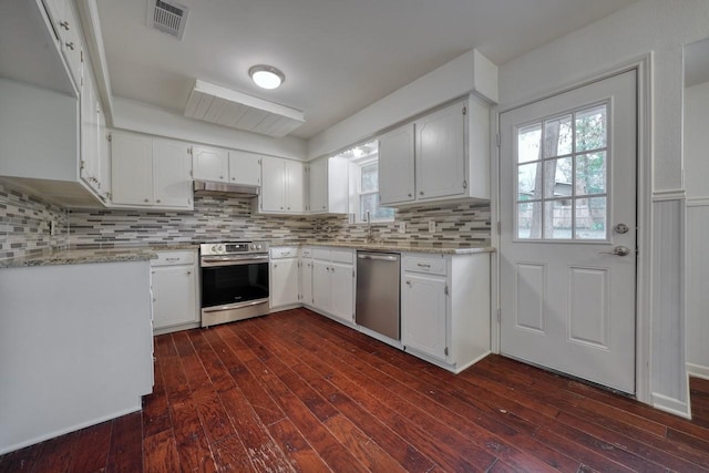 kitchen featuring white cabinetry, dark wood-type flooring, light stone counters, and appliances with stainless steel finishes