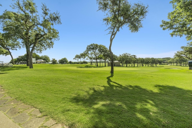 view of property's community with a lawn