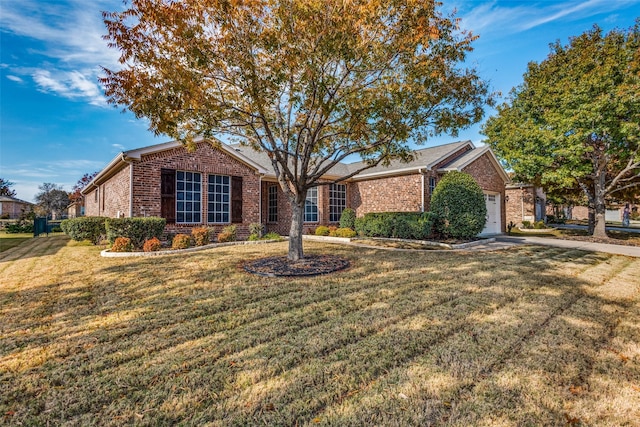 ranch-style home featuring a front yard and a garage