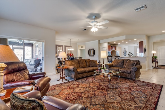 tiled living room featuring ceiling fan with notable chandelier and crown molding