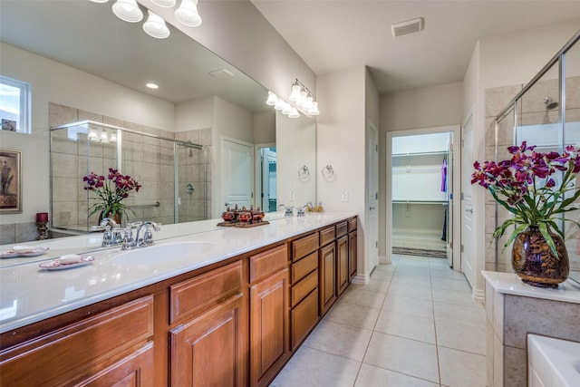 bathroom featuring tile patterned flooring, vanity, and walk in shower