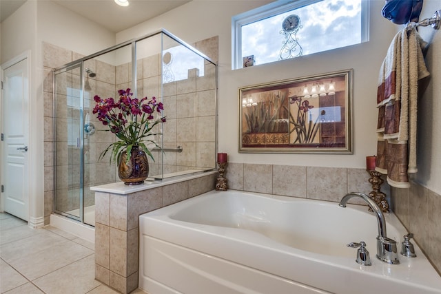 bathroom featuring tile patterned flooring and shower with separate bathtub