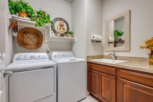 laundry area featuring sink, light tile patterned floors, and independent washer and dryer