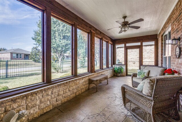 sunroom with plenty of natural light and ceiling fan