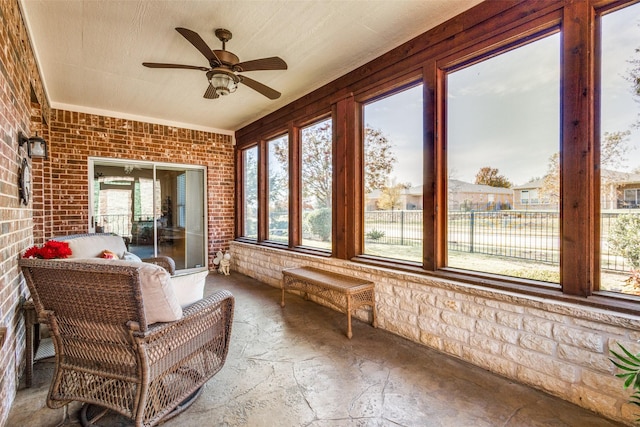 sunroom featuring ceiling fan