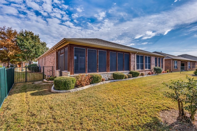 exterior space with a yard and a sunroom