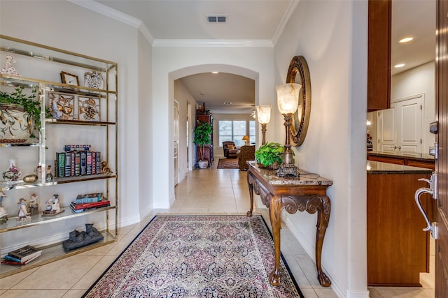 corridor featuring light tile patterned floors and ornamental molding