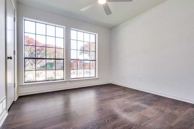 spare room with ceiling fan and dark hardwood / wood-style flooring