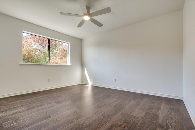 spare room featuring dark hardwood / wood-style floors and ceiling fan