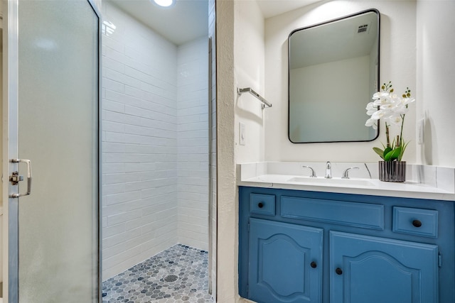 bathroom with vanity and a shower with shower door