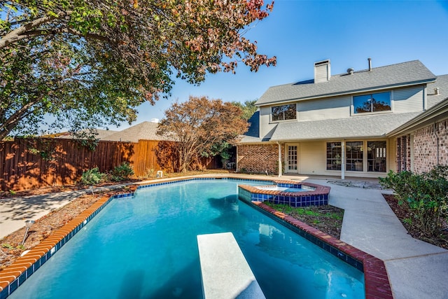 view of swimming pool with an in ground hot tub, a patio, and a diving board