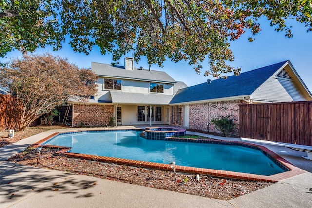 view of pool with an in ground hot tub