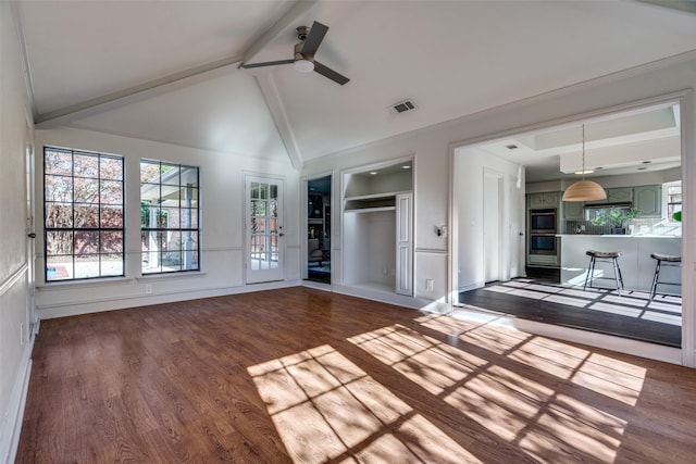 unfurnished living room featuring hardwood / wood-style floors, lofted ceiling with beams, and ceiling fan