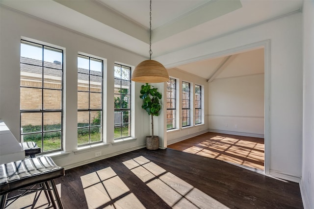 interior space featuring a raised ceiling, vaulted ceiling, crown molding, and dark wood-type flooring