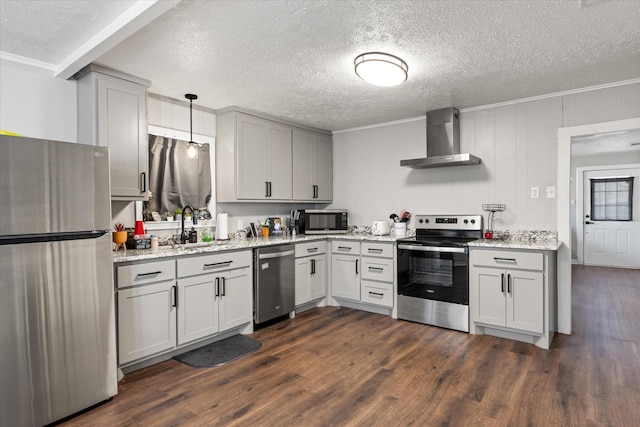 kitchen featuring pendant lighting, wall chimney range hood, sink, dark hardwood / wood-style flooring, and stainless steel appliances