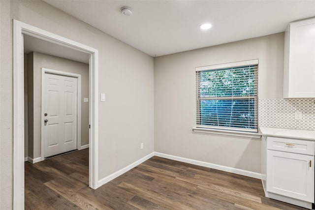 unfurnished dining area with dark hardwood / wood-style floors