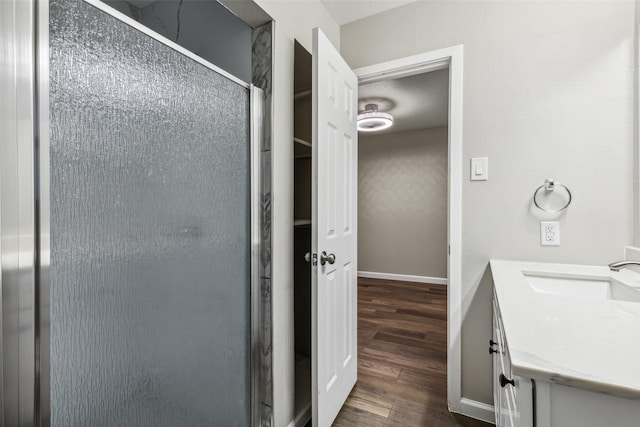 bathroom with vanity, wood-type flooring, and walk in shower