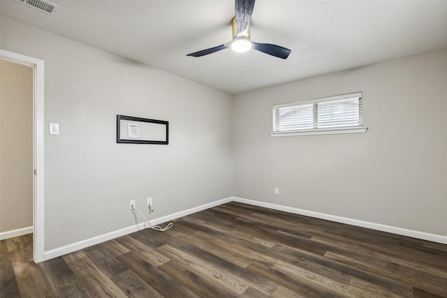 spare room featuring ceiling fan and dark wood-type flooring