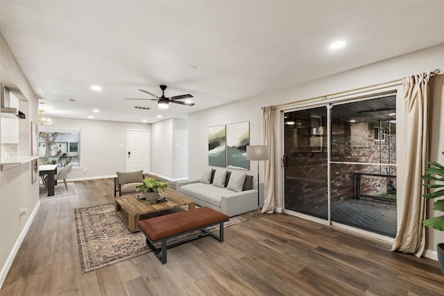 living room featuring a textured ceiling, dark hardwood / wood-style floors, and ceiling fan