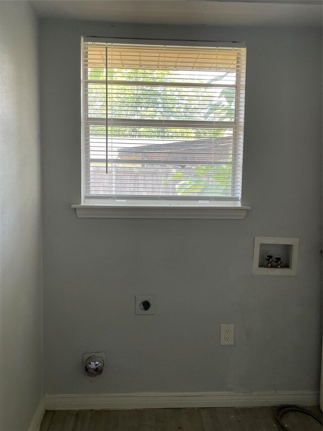 laundry room featuring hookup for an electric dryer, hookup for a washing machine, wood-type flooring, and a wealth of natural light