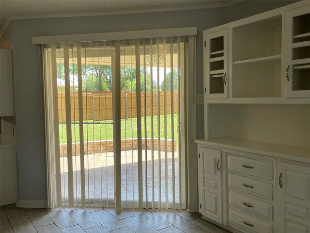 doorway featuring a wealth of natural light and light tile patterned floors