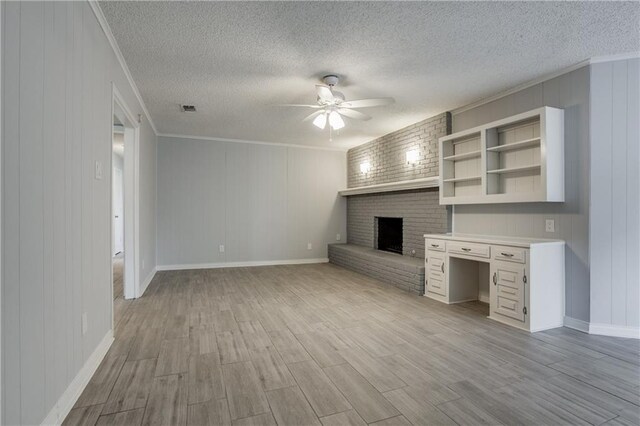 unfurnished living room featuring a textured ceiling, light hardwood / wood-style flooring, and ceiling fan