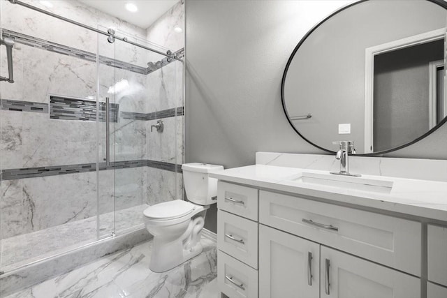 bathroom featuring vanity, toilet, and a shower with shower door