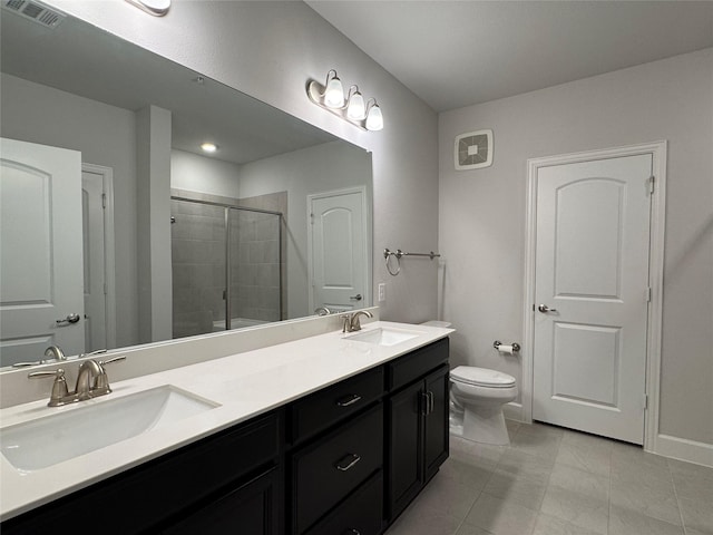 bathroom featuring tile patterned flooring, vanity, toilet, and a shower with shower door