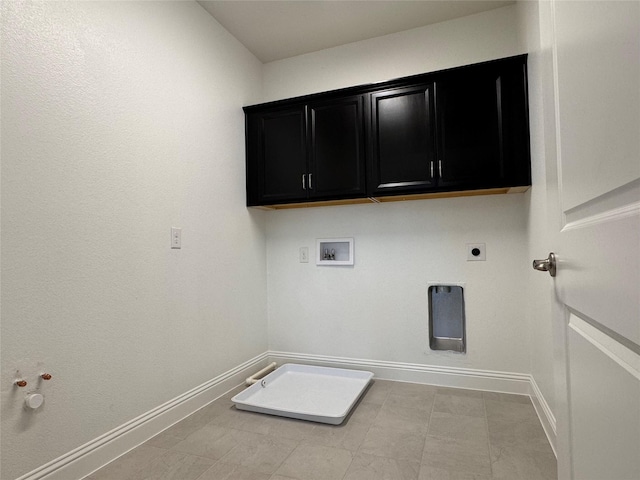 laundry area featuring cabinets, washer hookup, electric dryer hookup, hookup for a gas dryer, and light tile patterned floors