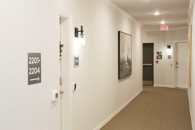 hall with carpet and ornamental molding