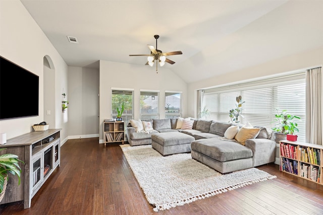 living room featuring dark hardwood / wood-style floors, vaulted ceiling, and ceiling fan