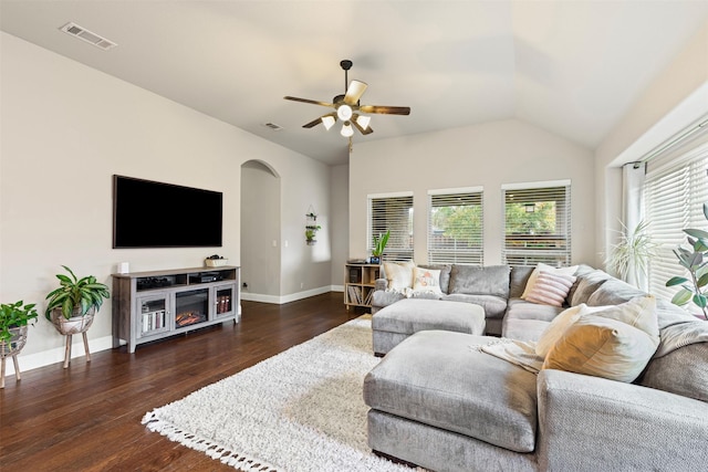 living room featuring dark hardwood / wood-style floors, vaulted ceiling, and ceiling fan