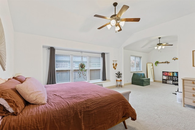 carpeted bedroom with multiple windows, ceiling fan, and lofted ceiling