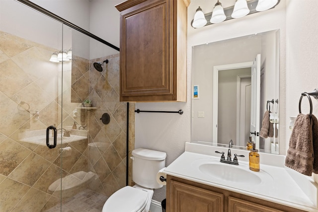 bathroom with vanity, toilet, and a shower with shower door