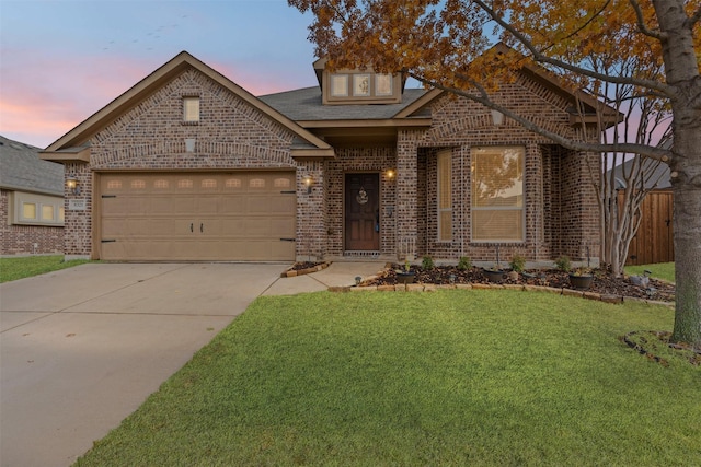 view of front of home with a garage and a yard