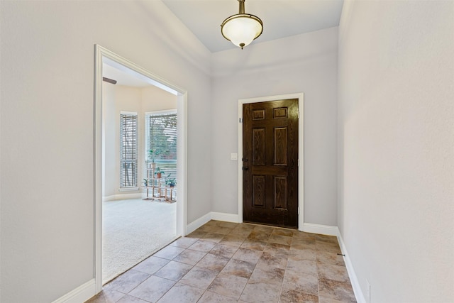 entrance foyer featuring light colored carpet