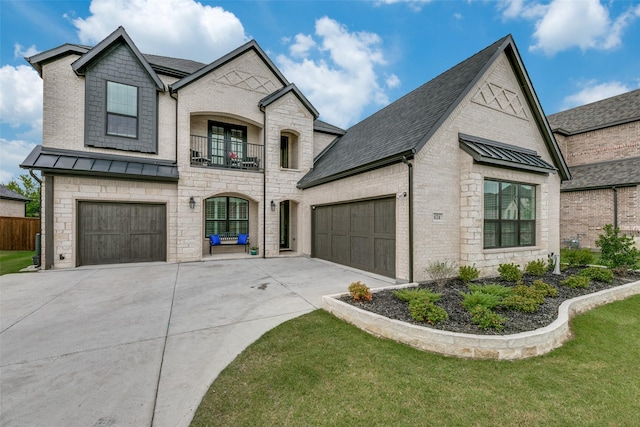 french country inspired facade featuring a balcony and a front lawn