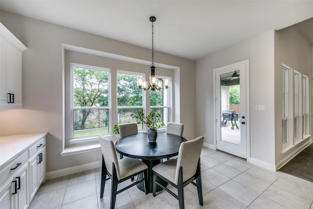 dining area with light tile patterned floors, a wealth of natural light, and baseboards