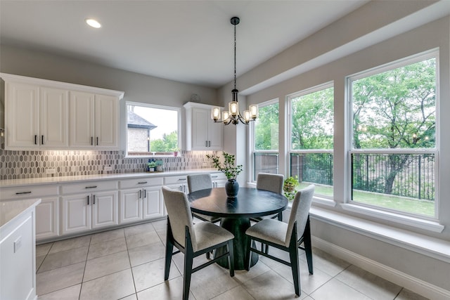 dining area with a chandelier, light tile patterned floors, recessed lighting, and baseboards