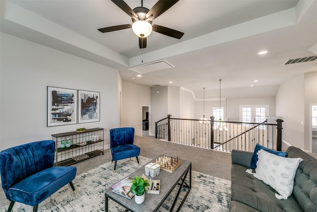 living area featuring attic access, baseboards, visible vents, and carpet flooring