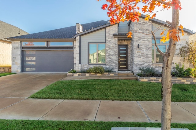 view of front facade with a garage and a front lawn