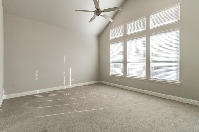 carpeted empty room featuring ceiling fan and high vaulted ceiling