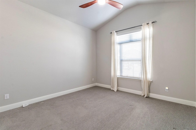 carpeted empty room with ceiling fan and vaulted ceiling