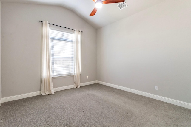 carpeted spare room with ceiling fan and vaulted ceiling