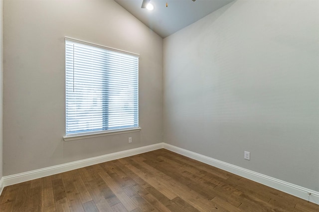 empty room featuring hardwood / wood-style floors, ceiling fan, and vaulted ceiling