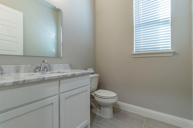 bathroom with vanity, tile patterned floors, and toilet