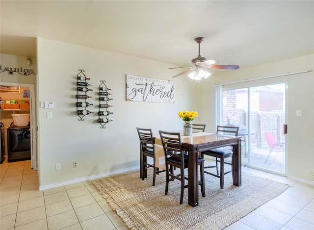 tiled dining room featuring ceiling fan and separate washer and dryer