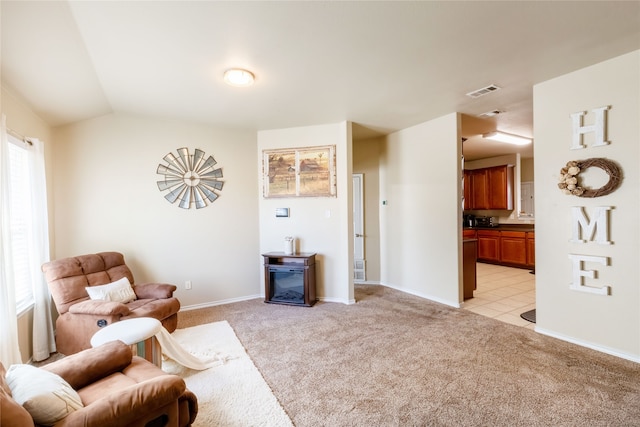 living room featuring plenty of natural light, light colored carpet, and vaulted ceiling